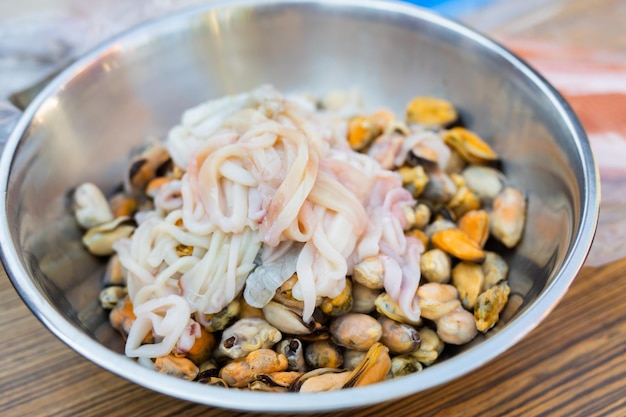 a plate of raw seafood for preparing a traditional dish