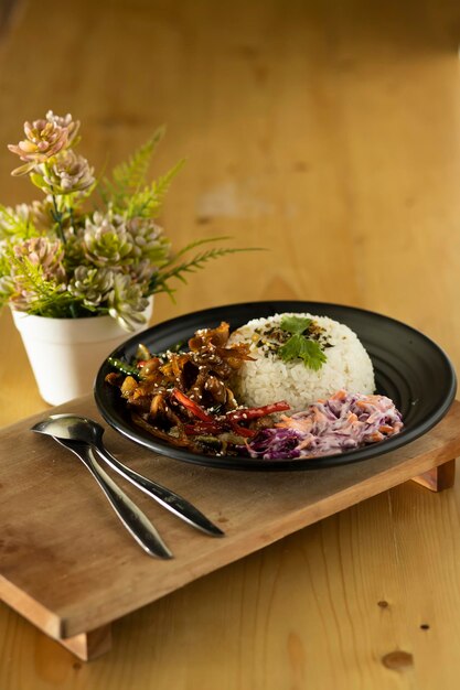 Plate of rice with sliced meat on flower background in vase