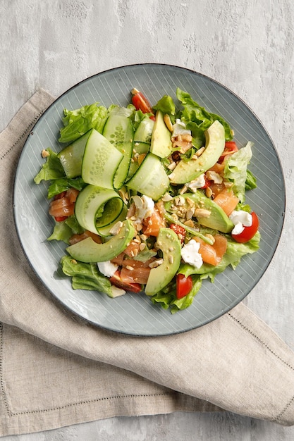 Plate of salad on light grey concrete background