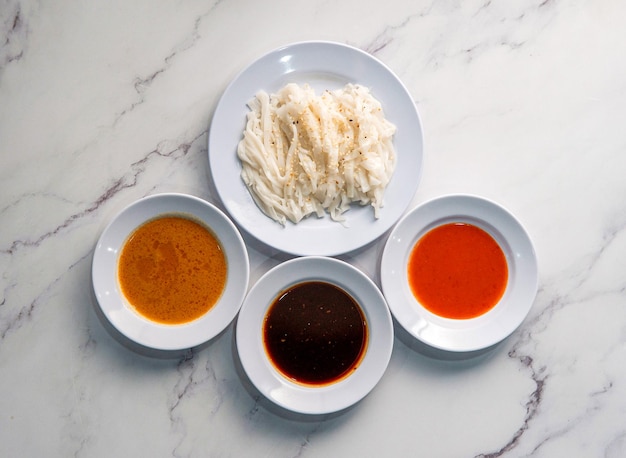 A plate of sauces with different sauces on it