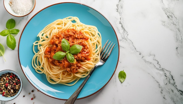 a plate of spaghetti with basil on it sits on a marble table