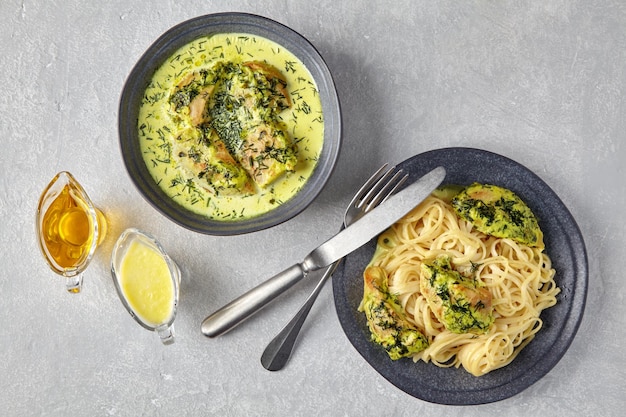 Plate of spaghetti with fried chicken baked with herbs and cream sauce