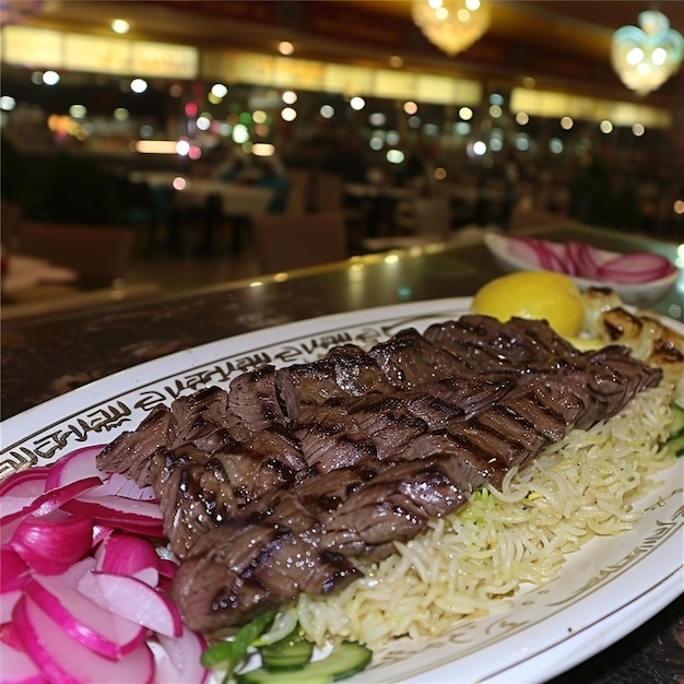 a plate of steak and rice with a lemon wedge on the side