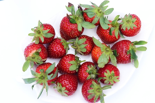 A plate of strawberries on a white background