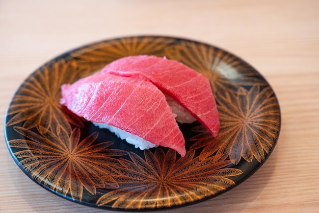 A plate of sushi with a leaf pattern on it