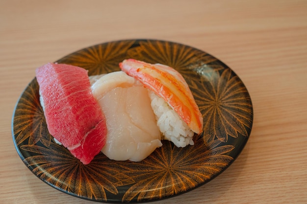 A plate of sushi with a pink and red claw.