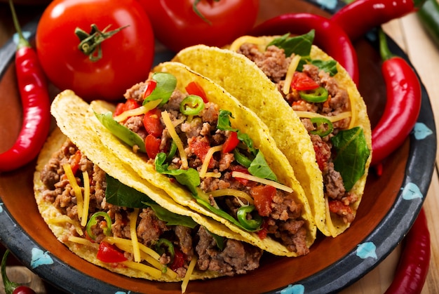 Plate of tacos on wooden table