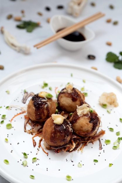 A plate of takoyaki over a marble table