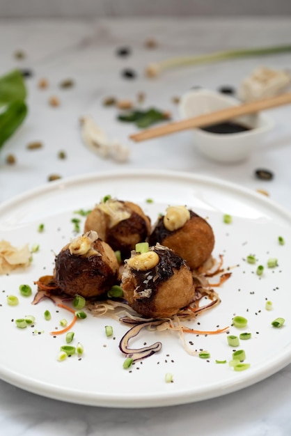 A plate of takoyaki over a marble table