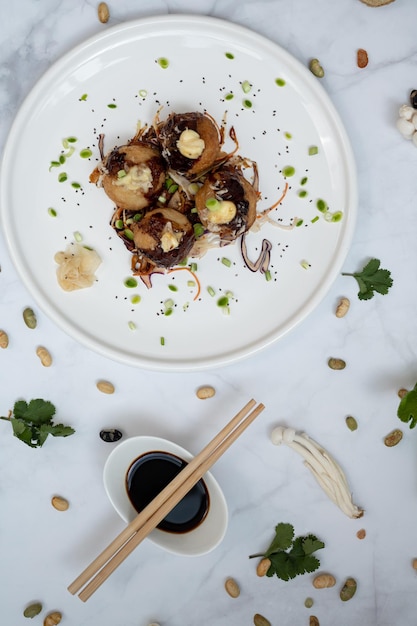 A plate of takoyaki over a marble table