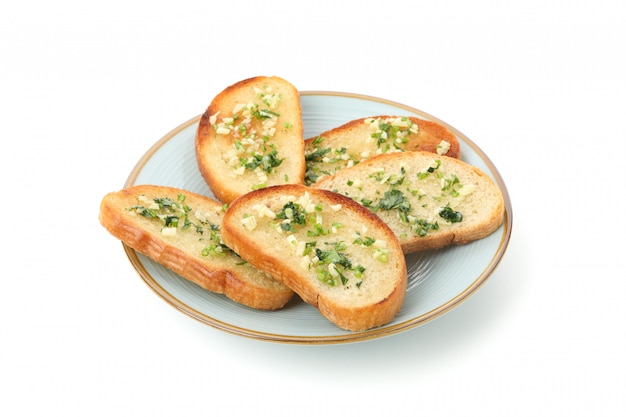 Plate of toasted bread slices with garlic isolated on white