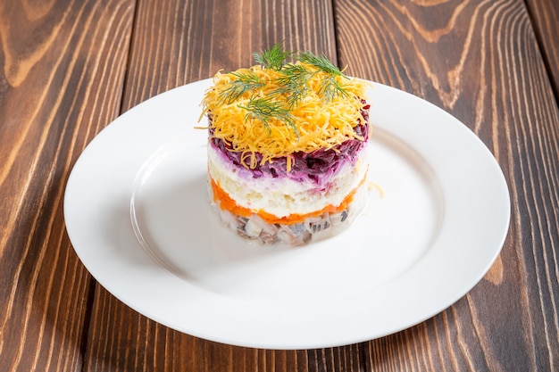 Plate of traditional russian salad called dressed herring