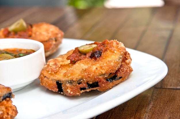 plate of weathered eggplants accompanied by Mexican sauce and green olives italian food gastronomy