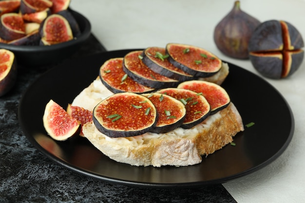 Plate with bruschetta with fig on two tone background