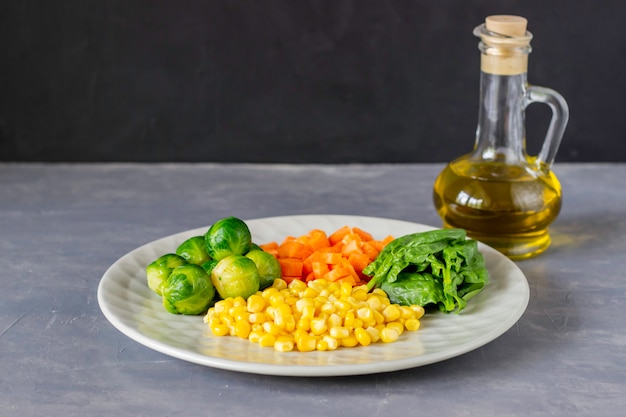 Plate with cabbage, carrots, corn and spinach 