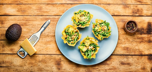 Plate with cheese basket with avocado,cowpea and nuts.Banquet,holiday food