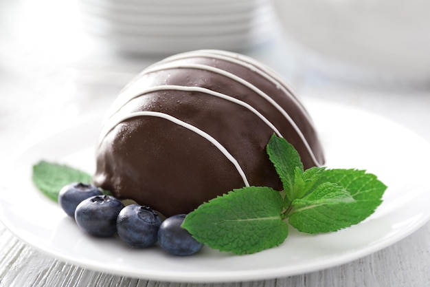 Plate with chocolate dessert on table