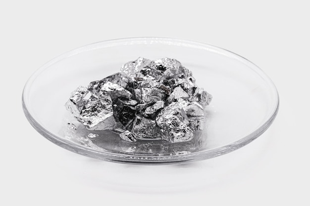 Plate with chromium ore industrial use ore metallic chemical element isolated on white background