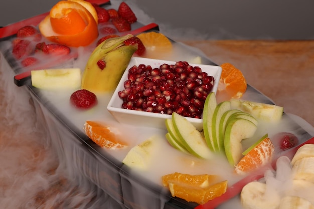 Plate with delicious mixed fruits and sliced fruits