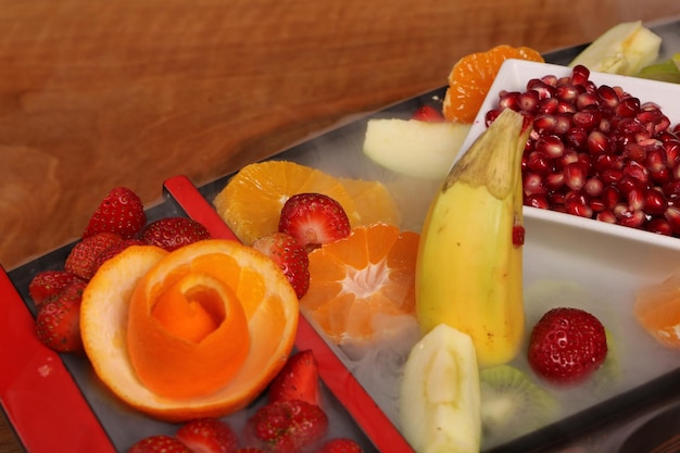 Plate with delicious mixed fruits and sliced fruits