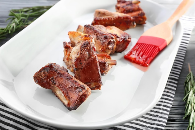 Plate with delicious pork ribs closeup