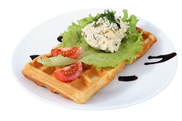 Plate with fast food, Belgian waffle, side dish, tomato slices, lettuce leaf, isolated image on white background.