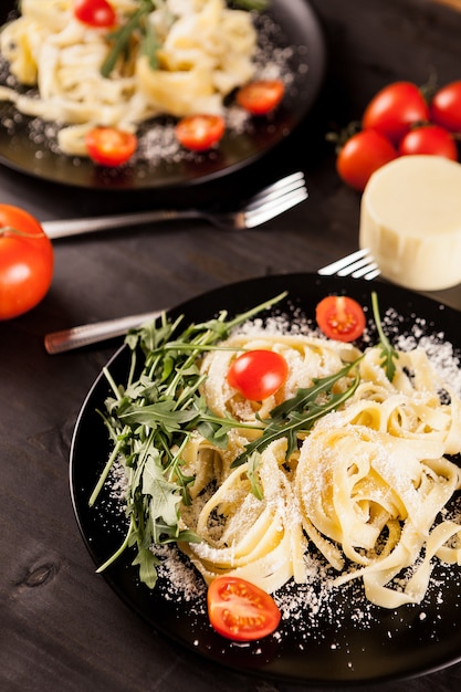 Plate with healthy and delicious italian pasta on wooden background