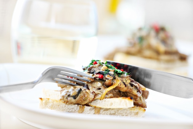 Plate with mushroom and meat in sauce