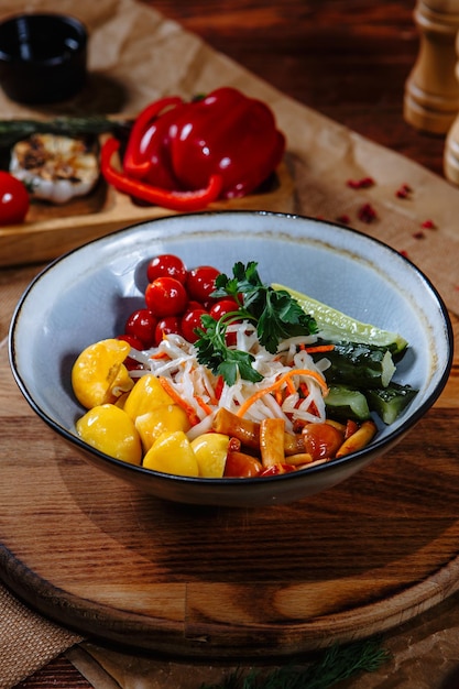 A plate with salted pickled vegetables and mushrooms Top view