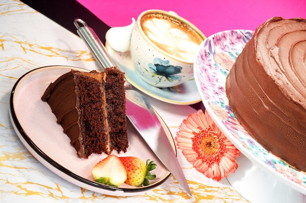 A plate with a slice of cake and a cup of coffee on it