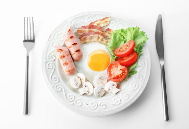 Plate with tasty egg for breakfast on white background