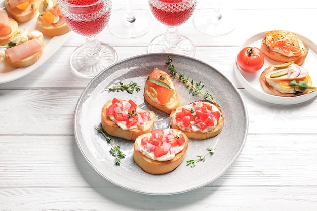 Plate with tasty fresh bruschettas on table