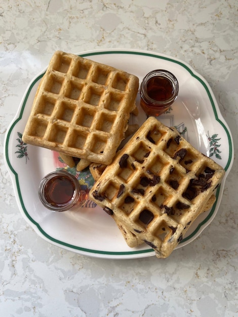 a plate with waffles and syrup on it