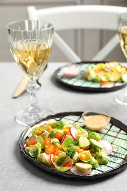 Plate with yummy brussel sprouts salad on table