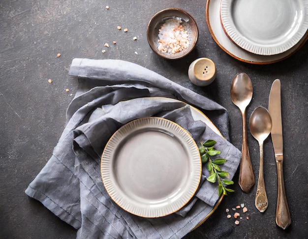 Photo plates cutlery and tablecloth on black table top view