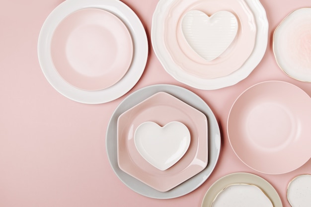 Plates and dishes for serving a festive table on pastel colors background. Flat lay, top view.