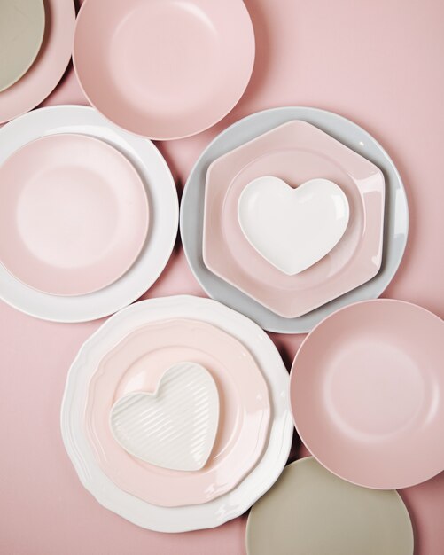 Plates and dishes for serving a festive table on pastel colors background. Flat lay, top view.