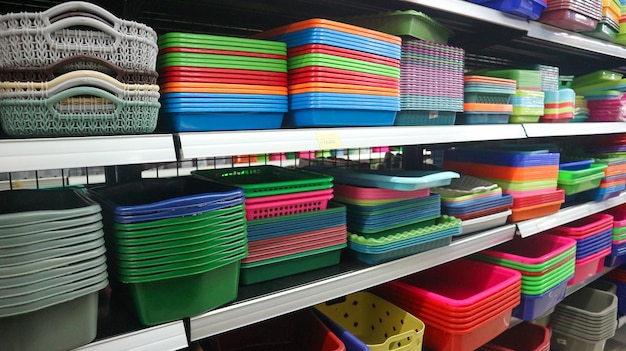 plates plastic buckets bowls food storage containers and kitchen utensils on supermarket shelves