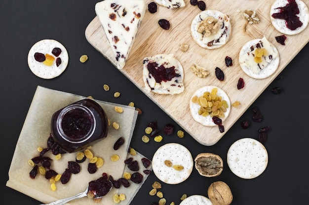 Photo platter with crackers and cranberry cheese with walnut raisin jam and dried cranberry