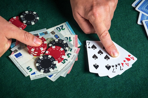 Player points with his finger at a winning two pairs combination in a poker game