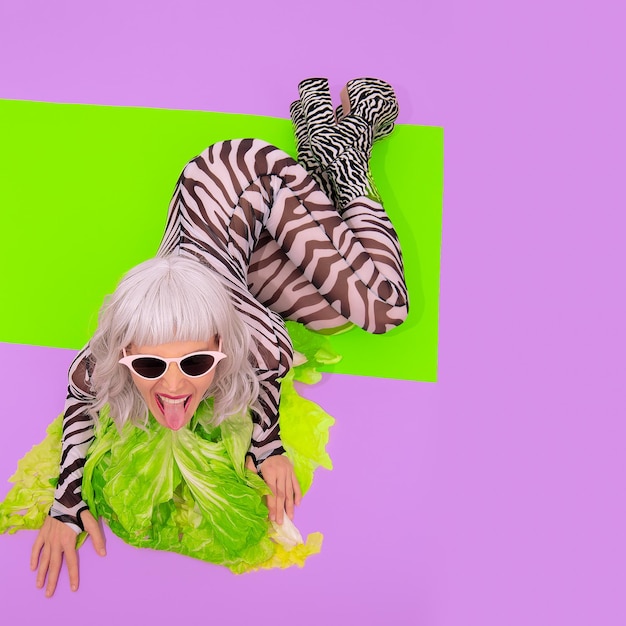 Playful Blonde in fashion zebra print clothes with fresh salad green Go vegan animal lover Diet healthy food calories concept Raw vegan partyxA