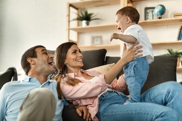 Playful family having fun while spending time together at home Focus is on mother