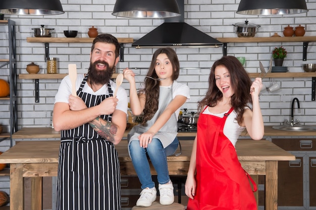 Playful mood mother father and child cooking family bonding time happy family in kitchen best team ever family in kitchen making breakfast together small girl have fun with mom and dad