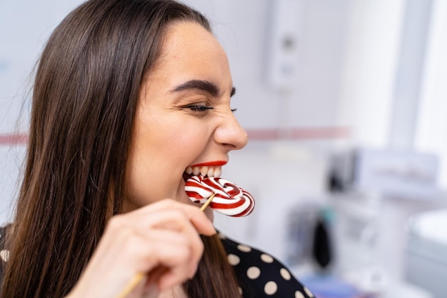 A Playful Woman Enjoying a Candy Cane A woman holding a candy cane in her mouth