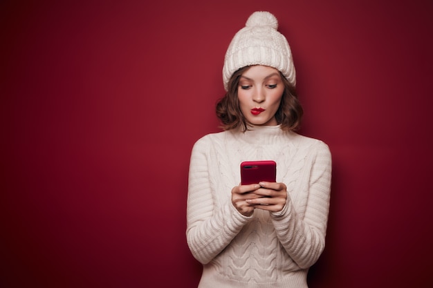 Playful woman typing in phone