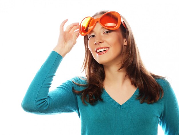 Playful young woman with big party glasses.