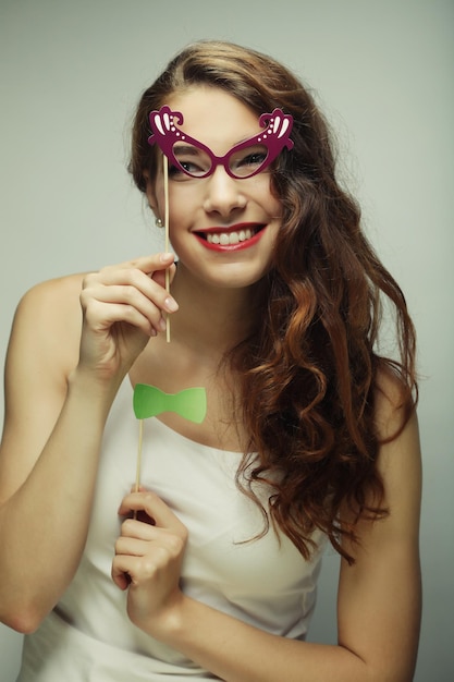 Playful young women holding a party glasses