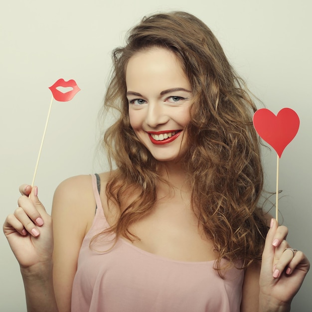 Playful young women holding a party heart