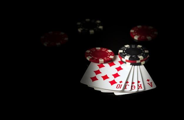 Playing cards on a black table with a winning combination four of a kind or quads