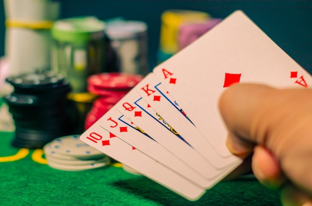 Playing cards with money and chips in the casino.